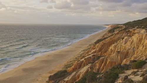 A Beautiful Beach with a Rocky Cliff in the Background
