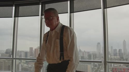 Wide shot of an angry CEO standing up and hitting the table in anger