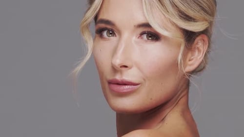 Studio Portrait of Young and Beautiful Blond Woman Over Grey Background Skin Care and Wellness