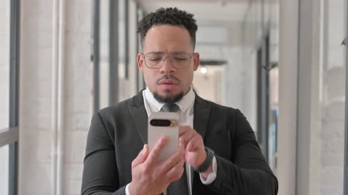 Man Celebrates Good News on Phone