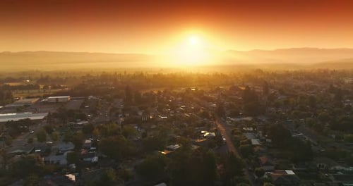 Amazing orange bright sky over Napa, California, USA. Drone flying over the cozy houses