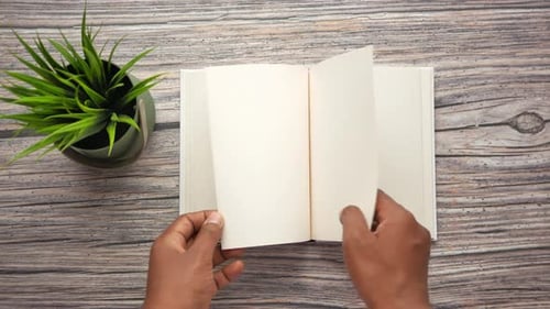 Top View of Hand Turning a Pager of a Diary