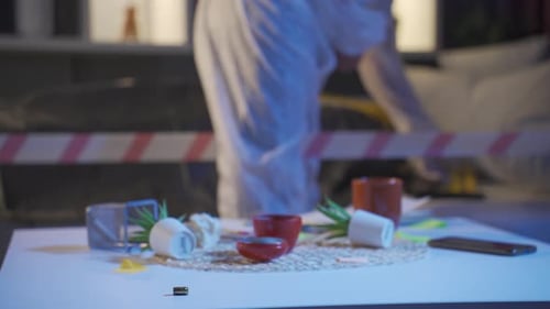 Crime Scene Investigator Collects Evidence Indoors