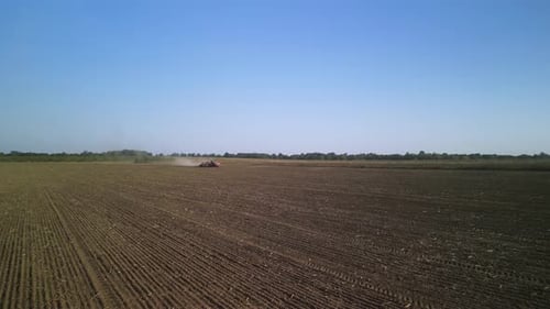 Tractor on the field seeding wheat