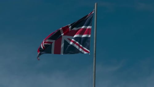 UK Flag Waving Against a Blue Sky