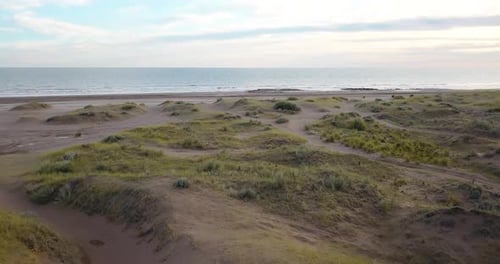 Aerial View Of Sand Dunes And Beach At Sunset.