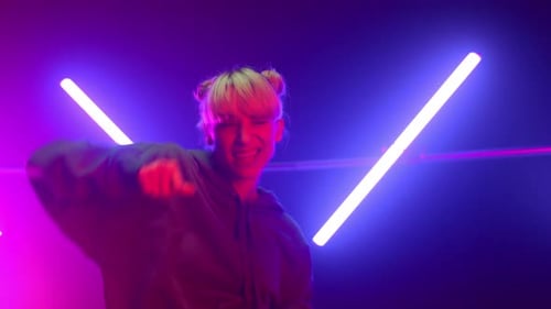 Energetic hip hop dancer performance in club ultraviolet lights close up studio show