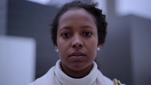 Close Up Young African American Businesswoman Standing Outside Business Center Looking at Camera