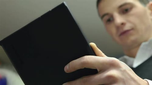 Man Using Tablet Indoors, Wearing Business Attire