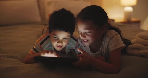 Kids, tablet and cartoon on bed at night, typing and digital technology by games with love in home
