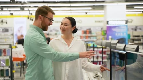 Young Couple Shopping for Electronics in Store