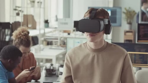 Young Man in VR Headset in Office