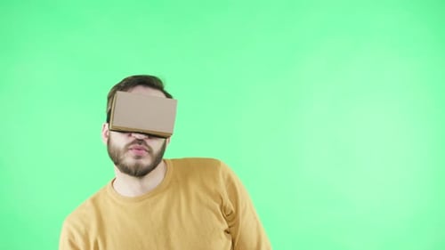 Shocked man wearing virtual reality glasses experiencing futuristic technology fun