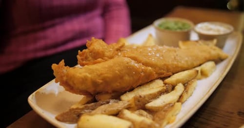 English Fish And Chips With Dipping Sauce. - close up