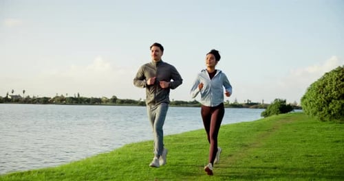 Couple Running Outdoors Along Lakeside Path