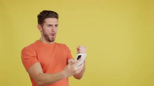 Man Reacting to Phone Message with Excitement
