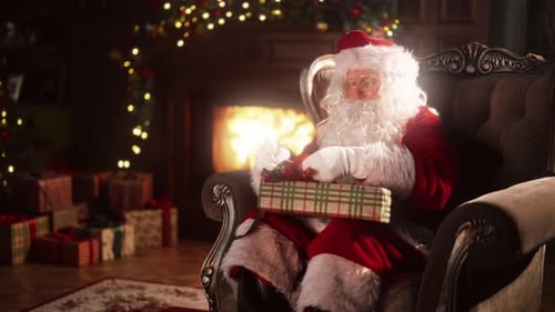 Santa Claus Wrapping a Gift by the Fireplace