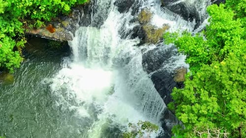 A waterfall in a beautiful tropical forest. Drone view.