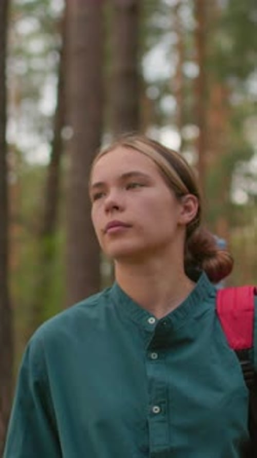 Young Woman Hiking Through Peaceful Forest Trail with Friend