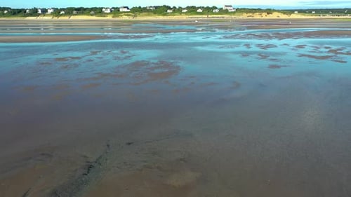 Cape Cod Bay Aerial Drone Footage of Bay Side Beach at Low Tide Flying Towards Beach Front Houses