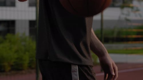 Only Hands Close Up Concept. Confident Sportsman Bouncing the Ball at Basketball
