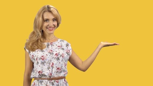 Happy Caucasian Woman Shows Copy Space Left Hand