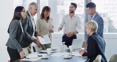 Professionals Discussing Graphs at a Conference Table