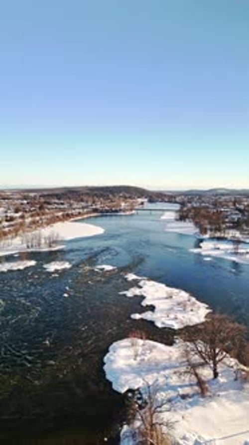 Aerial View of River Water Flowing Through Natural Landscape in Canada. Vertical Shot.