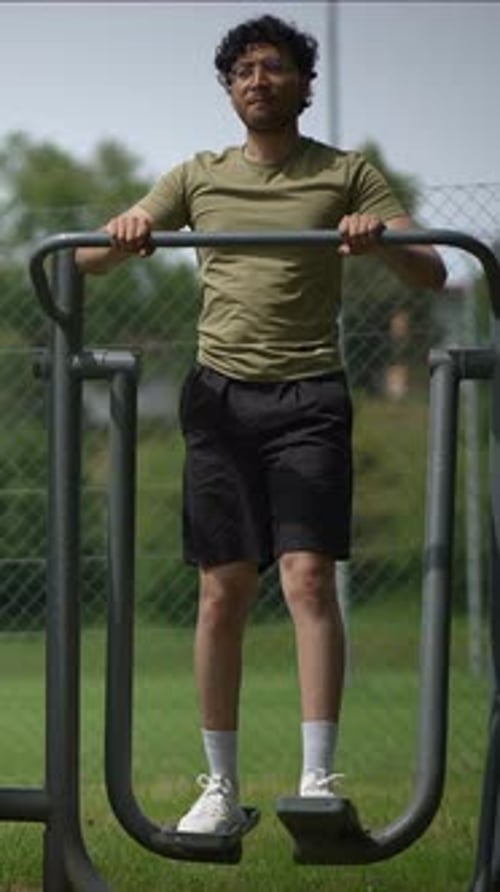 Man Working Out on Outdoor Exercise Equipment