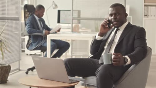 Black Businessman Talking on Phone in Office