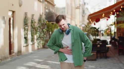 Man Tourist Feeling Sudden Strong Abdominal Stomach Ache Diarrhea Gastritis Problem on City Street