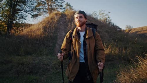 Man Hiking with Backpack on Rural Trail