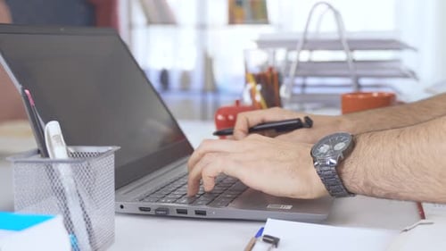 Man Working on Laptop at Desk