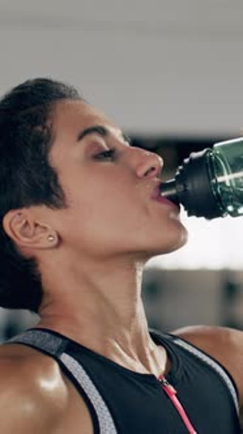 Fitness, rest and woman in gym with water, hydration drink and break in training routine