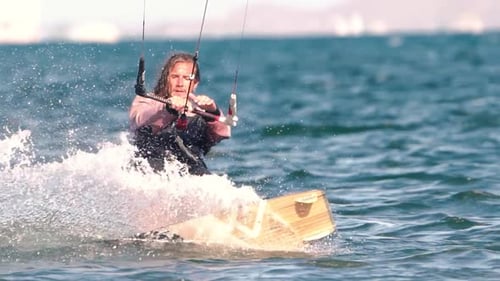 Sportsman practicing kite surf sport at the beach on a windy day at the Spanish coasts