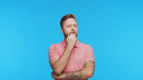 Thinking Young Man Over Vibrant Background Studio Portrait of Expressive Handsome Person