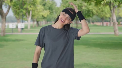 Happy Indian girl doing neck stretching