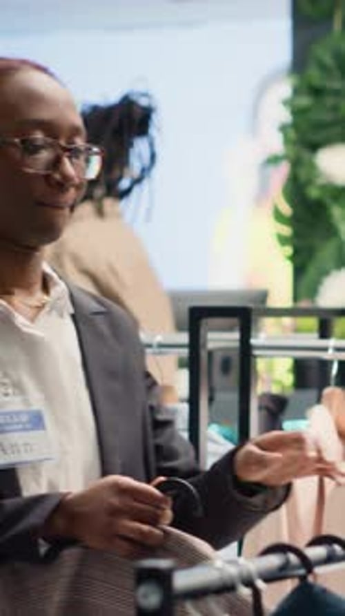 Woman Smiling in Corporate Environment with Clothing Rack