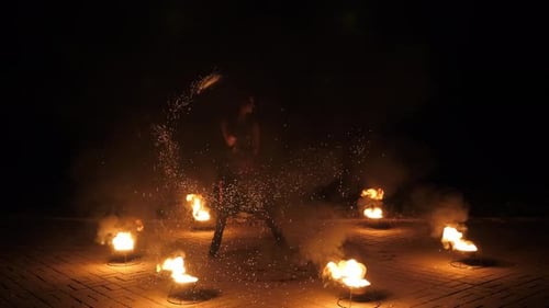 Fire Dancer Performing with Flames at Night