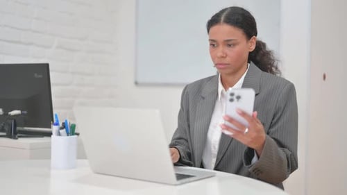 Young Adult Woman Working at Desk with Technology