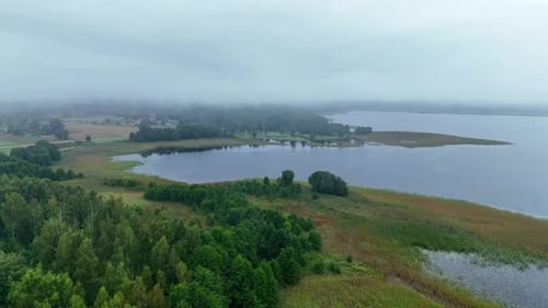 Drone Lateral Shot of Foggy Lake and Misty Shores