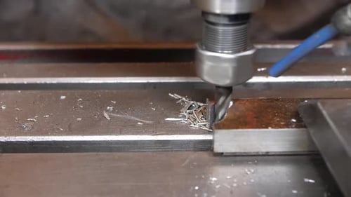 Making Hole in Metal Piece with Automatic Drilling Machine
