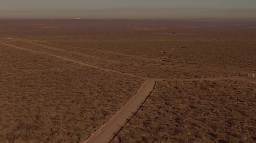 Aerial Desert Road at Sunset Evokes Peaceful Isolation in the desert