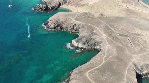 Aerial view of rocky cliffs and turquoise water, Spain.