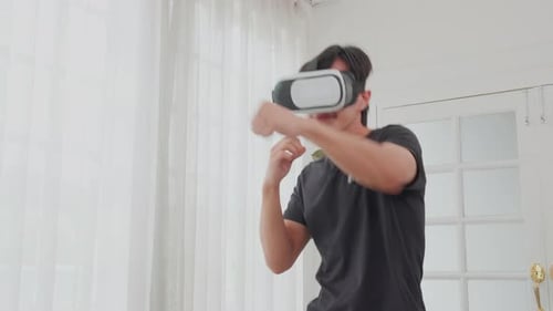 Young Adult Wearing VR Headset Shadow Boxing