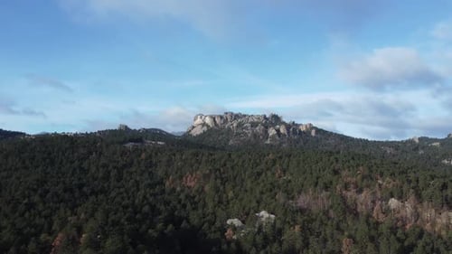 Stunning Panoramic View Of Rugged Rocky Peaks Over Vast Forest