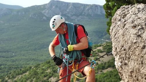 Climber Snaps the Safety Carabiner on the Rope