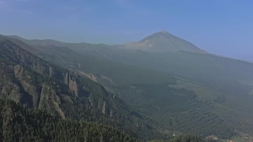 Aerial View of Mountainous Terrain with Volcano