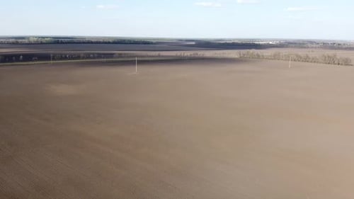 Tractor with yellow seeder working on the field in Ukraine OA Lexa