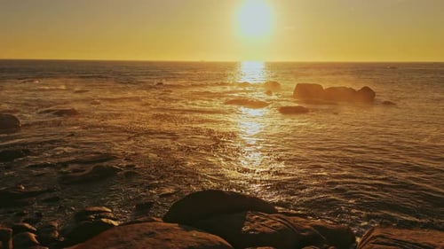 Golden Sunrise over a Rocky Coastline